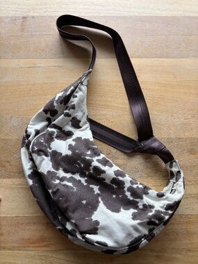 Cow Print Crescent Crossbody Bag with Red Bandana Print inside